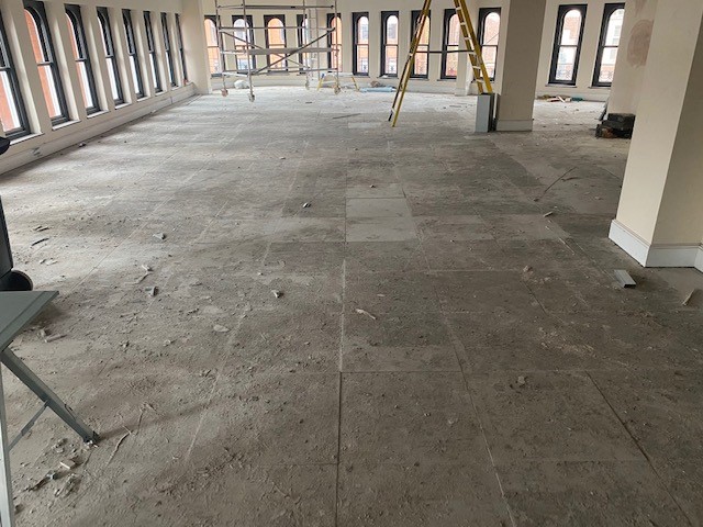 Raised metal access floor contaminated by adhesive